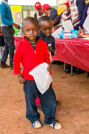 Soweto, South Africa - July 18, 2016: Young African Preschool kids eating sandwiches in the playground of a kindergarten schoolのeditorial素材