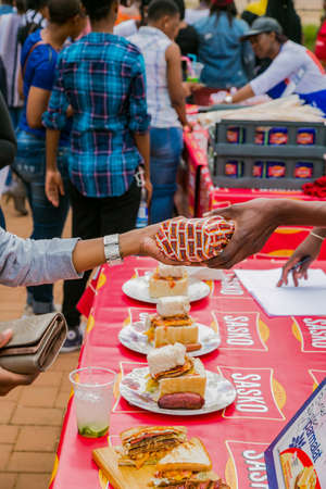 Soweto, South Africa - September 17, 2017: Diverse African vendors cooking and serving various bread based street food at outdoor festivalのeditorial素材