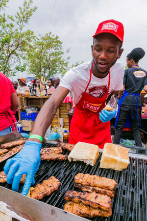 Soweto, South Africa - September 17, 2017: Diverse African vendors cooking and serving various bread based street food at outdoor festivalのeditorial素材