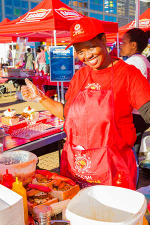 Soweto, South Africa - September 8, 2018: Diverse African vendors cooking and serving various bread based street food at outdoor festivalのeditorial素材