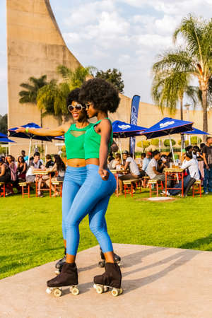 Johannesburg, South Africa - September 11, 2015: Two African girls with Afro hair styles on roller Skatesのeditorial素材