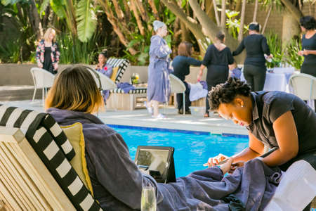 Johannesburg, South Africa - May 10, 2018: Diverse women in bath robes receiving a pedicure at spa resortのeditorial素材