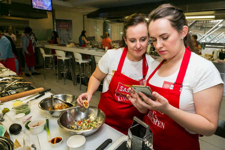 Johannesburg, South Africa - November 10, 2016: Young women learning to cook and bake at a cooking classのeditorial素材