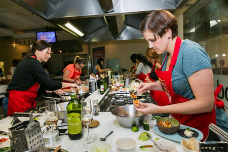 Johannesburg, South Africa - November 10, 2016: Young women learning to cook and bake at a cooking classのeditorial素材