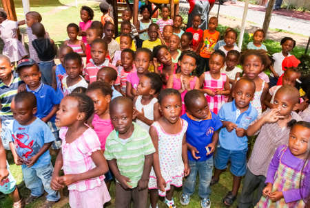 Soweto, South Africa - November 16, 2012: Young African Preschool kids singing songs in the playground of a kindergarten schoolのeditorial素材