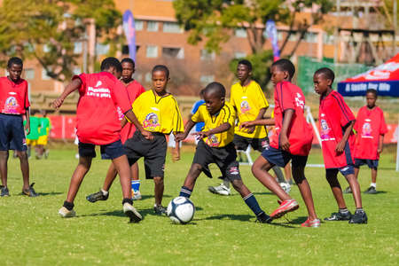 Johannesburg, South Africa - June 29 2009:  Diverse children playing soccer football at schoolのeditorial素材