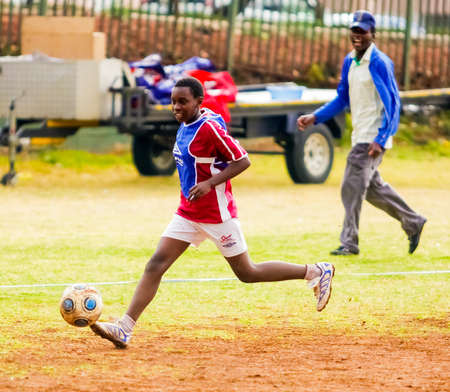 Johannesburg, South Africa - August 27 2009: Diverse children playing soccer football at schoolのeditorial素材