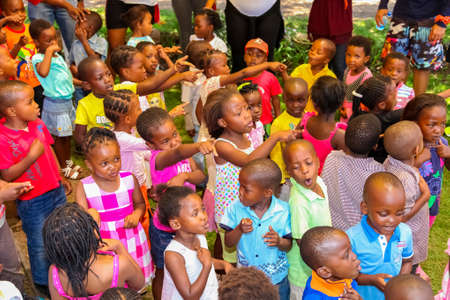 Soweto, South Africa - November 16, 2012: Young African Preschool kids singing songs in the playground of a kindergarten schoolのeditorial素材