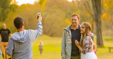 Johannesburg, South Africa, 05/09/2015, Young beautiful couple posing for a selfie at The Winter Sculpture Fair at Nirox Sculpture Parkのeditorial素材