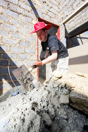 Soweto, South Africa - September 05, 2009: Diverse Community Outreach program helping to build a small affordable house in local townshipのeditorial素材