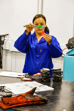 Johannesburg, South Africa - October 19, 2012: Female lab technician testing product samples in a...
