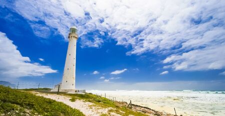 Lighthouse on the rugged Cape Town South Africa coastline during the dayの写真素材
