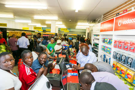 Johannesburg, South Africa - October 27, 2016: African cashier and customer at checkout at local...