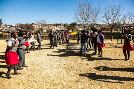 Johannesburg, South Africa - June 19, 2014: Diverse African high school pupils playing physical games on the sports fieldのeditorial素材