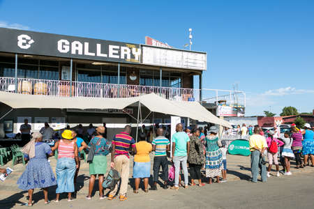 Soweto, South Africa - December 1, 2016: Customers waiting in line at entrance to local Pick n Pay...
