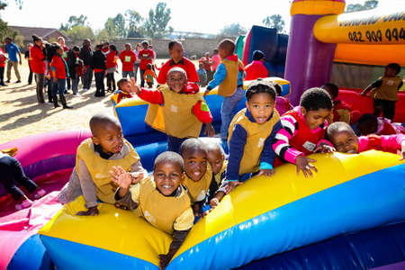 Soweto, South Africa - July 18, 2012: Young African Preschool children having fun on a jumping...