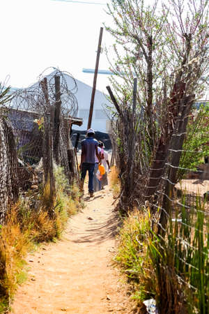 Johannesburg, South Africa, September 11, 2011, Back Ally dirt road path in suburban Soweto neighborhoodのeditorial素材