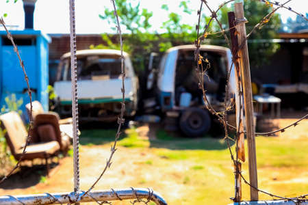 Johannesburg, South Africa, September 11, 2011, Scrapped Mini Bus Taxi in garden of Soweto Homeのeditorial素材