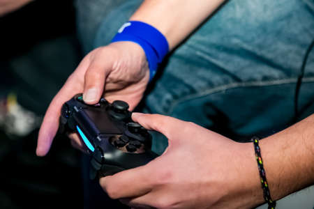 Johannesburg, South Africa - December 10 2013: Play Station PS4 controller in a gamers handsのeditorial素材