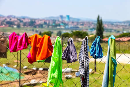 Johannesburg, South Africa - November 16 2012: Clothes and underwear hanging on a fence in suburban...