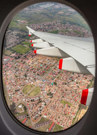 View of an airplane wing out the window from the seat inside a commercial jet airplaneのeditorial素材