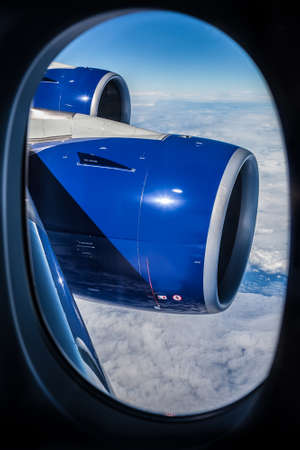 View of an airplane wing out the window from the seat inside a commercial jet airplane