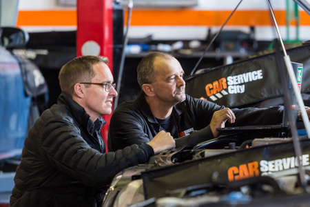 Johannesburg, South Africa - July 14, 2017: Mechanics in Car Service City Workshop repairing and...