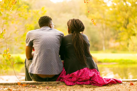 Johannesburg, South Africa, 05/10/2014, A couple relaxing next to a pond at The Winter Sculpture Fair at Nirox Sculpture Parkのeditorial素材