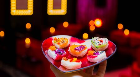 Soft Focus Valentines Day Heart Shaped Sushi Platter with Love lights in the backgroundの写真素材