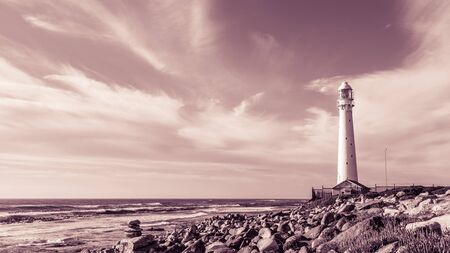 Slangkop Lighthouse near the town of Kommetjie in Cape Town, South Africa at Sunsetの写真素材