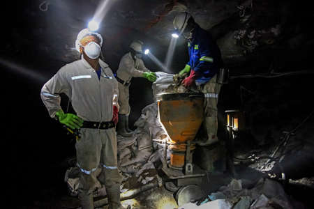 Rustenburg, South Africa, May 23, 2011, Underground Platinum Chrome miners mixing cement for wall...