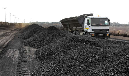 Witbank, South Africa - July 25 2011: Truck tipping processed coal for shipping at a railway sidingのeditorial素材