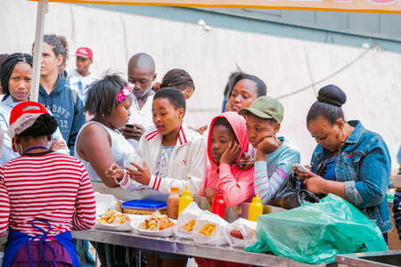 Soweto, South Africa - September 17, 2017: Diverse African people at a bread based street food outdoor festivalのeditorial素材
