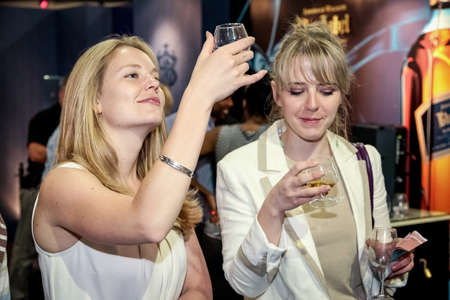 Johannesburg, South Africa - November 9, 2011: Young women tasting whiskey at Johnnie Walker branded barのeditorial素材