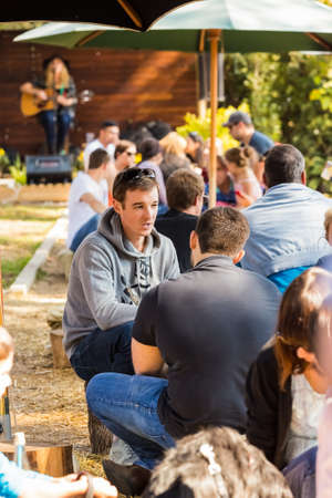 Johannesburg, South Africa - May 24, 2015: Crowds of diverse people sitting in the beer garden at outdoor farmer's marketのeditorial素材