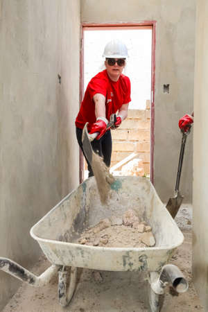 Soweto, South Africa, September 10, 2011, Diverse Community members join PWC's staff in building a low cost house as a team in Sowetoのeditorial素材