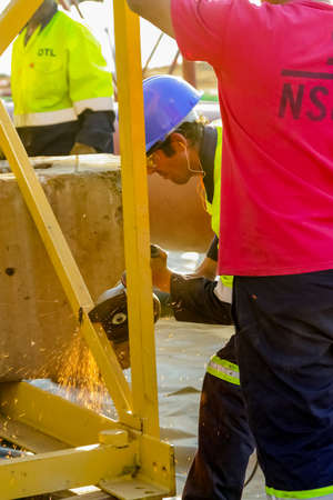 Johannesburg, South Africa - June 06 2010: Tradesman working with an angle grinder on a building siteのeditorial素材
