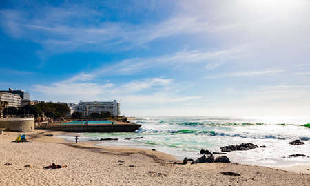 Cape Town, South Africa - October 13, 2019: Diverse people and children with dogs playing in the...