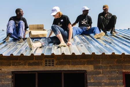 Soweto, South Africa - September 05, 2009: Diverse Community Outreach program helping to install...
