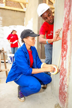 Soweto, South Africa, September 10, 2011, Diverse Community members join PWC's staff in building a low cost house as a team in Sowetoのeditorial素材