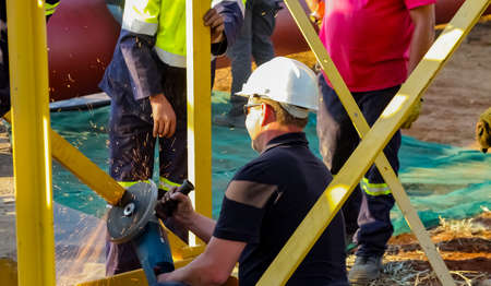 Johannesburg, South Africa - June 06 2010: Tradesman working with an angle grinder on a building...