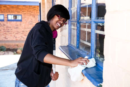 Soweto, South Africa - July 21, 2012: African Woman performing community service volunteer cleaning work at township schoolのeditorial素材