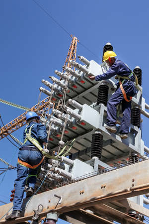 Johannesburg, South Africa, 04/11/2012, Electricians working on high voltage power lines. Highly...