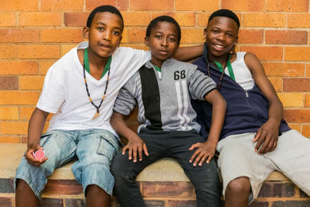 Johannesburg, South Africa - October 6, 2016: Three young African children displaying friendship and joy in a Soweto Townshipのeditorial素材