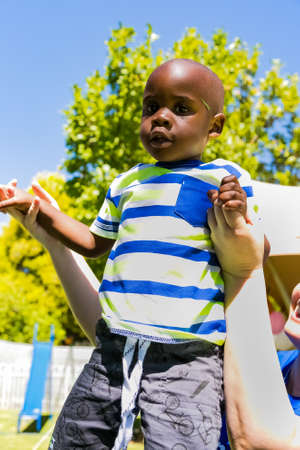Johannesburg, South Africa - December 14, 2017: Young African playing in the garden on a sunny dayのeditorial素材