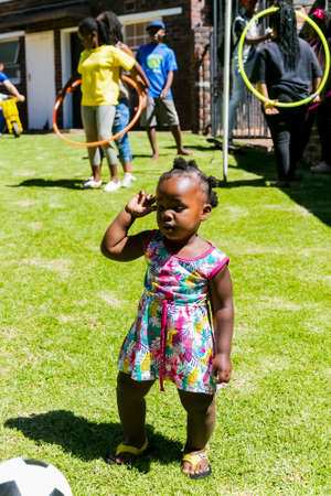 Johannesburg, South Africa - December 14, 2017: Young African children playing in a garden on a sunny dayのeditorial素材
