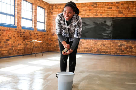Soweto, South Africa - July 21, 2012: African Women performing community service volunteer cleaning work at township schoolのeditorial素材
