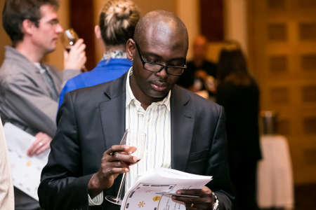 Johannesburg, South Africa - May 10 2013: Sophisticated people sampling wine at a wine tasting eventのeditorial素材