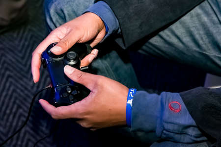 Johannesburg, South Africa - December 10 2013: Play Station PS4 controller in a gamers hands