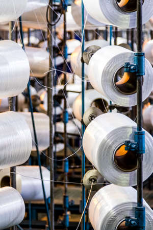 Johannesburg, South Africa - October 16, 2012: Cotton Thread Bobin on a copwinder weft assembly line loomのeditorial素材